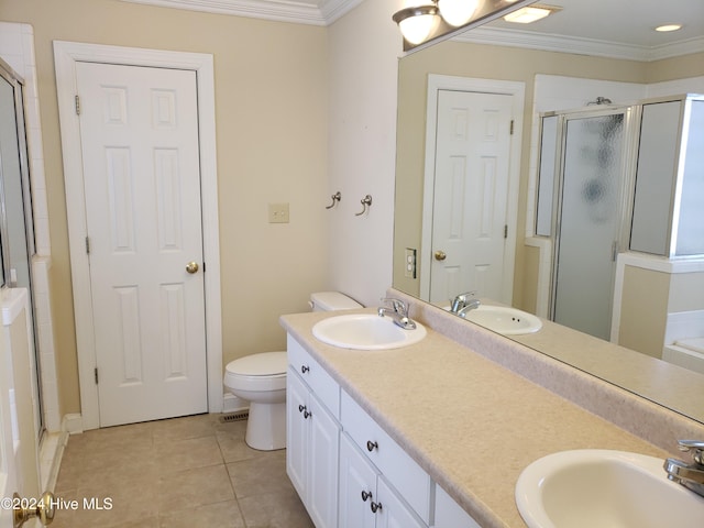 bathroom with vanity, tile patterned floors, toilet, ornamental molding, and walk in shower