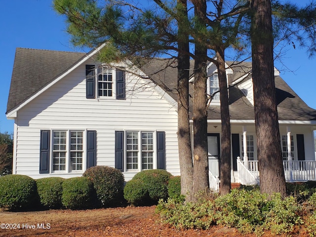 cape cod house featuring a porch