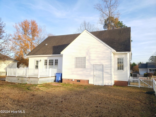 rear view of property featuring a deck