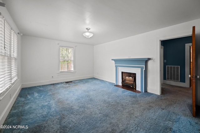 unfurnished living room featuring dark colored carpet