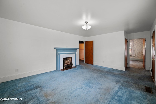 unfurnished living room featuring dark colored carpet