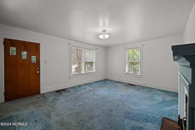 unfurnished living room featuring carpet