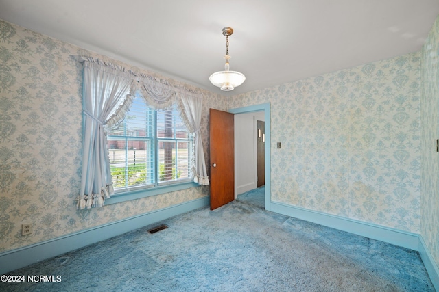 unfurnished room featuring carpet