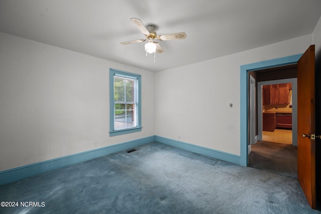 carpeted empty room with ceiling fan