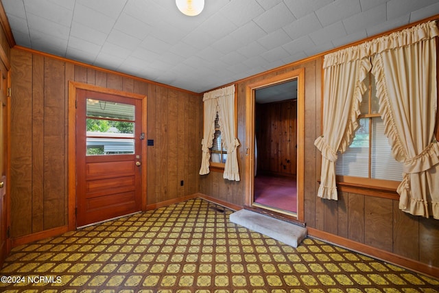 foyer with wooden walls