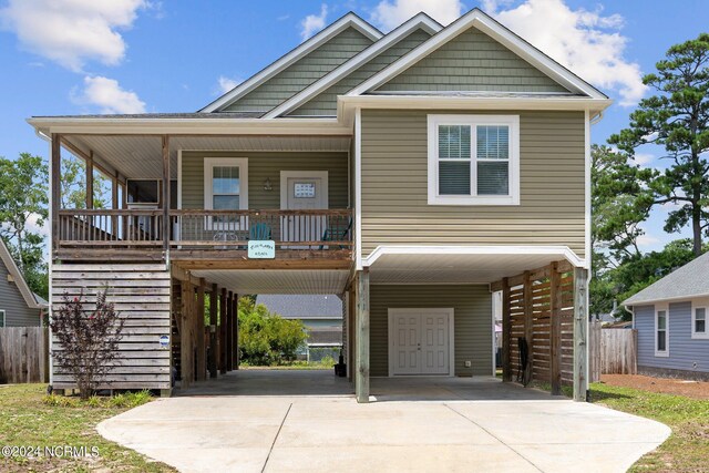 view of front of house with covered porch and a carport