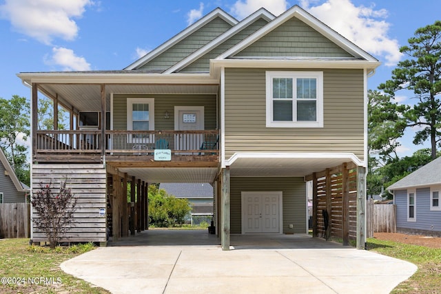 view of front of house with a carport and a porch