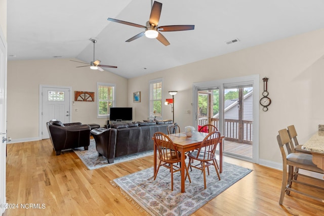 dining area with ceiling fan, lofted ceiling, and light wood-type flooring