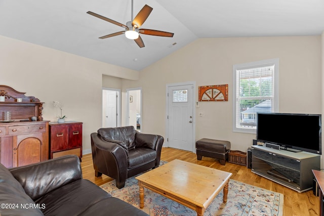 living room with lofted ceiling, ceiling fan, and light wood-type flooring