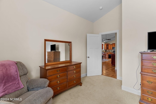 sitting room featuring lofted ceiling and light colored carpet