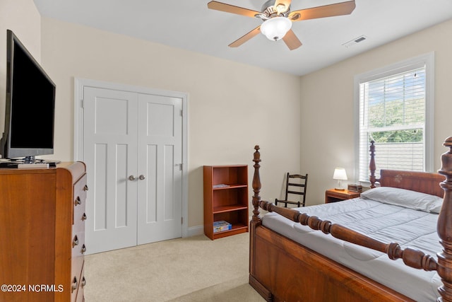 carpeted bedroom featuring a closet and ceiling fan