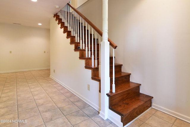 staircase with baseboards, tile patterned flooring, and recessed lighting