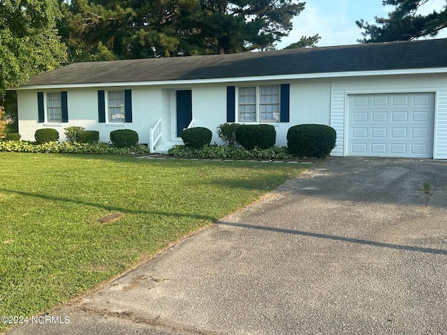 ranch-style house featuring a garage and a front yard