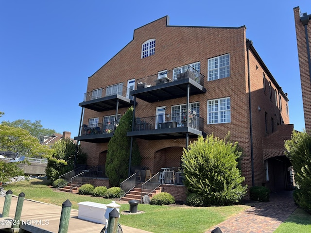 rear view of house featuring brick siding