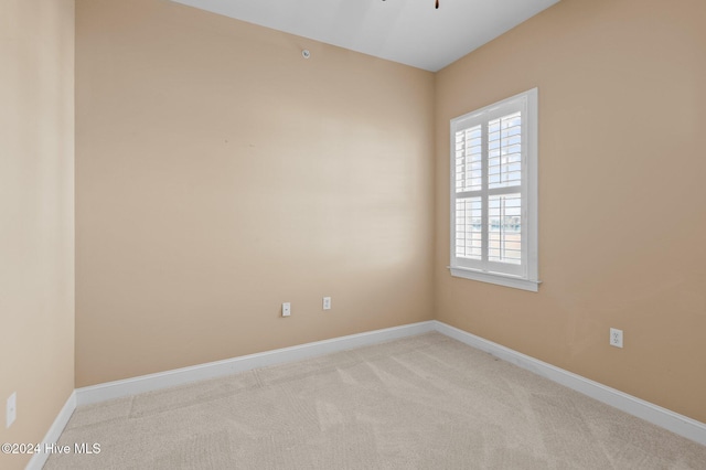 carpeted empty room with baseboards