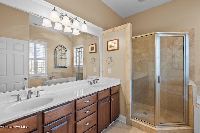 full bathroom with double vanity, a sink, and a shower stall