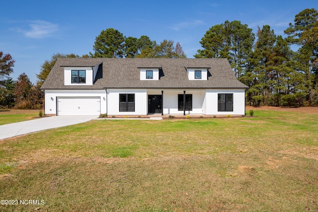 view of front of home featuring a front yard and a garage