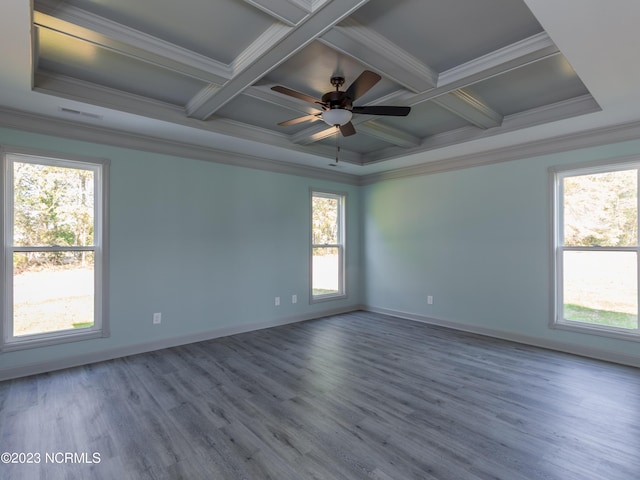 empty room featuring hardwood / wood-style flooring, coffered ceiling, ceiling fan, a healthy amount of sunlight, and crown molding