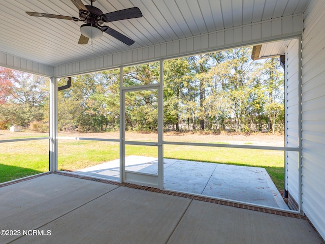 unfurnished sunroom with ceiling fan and a healthy amount of sunlight