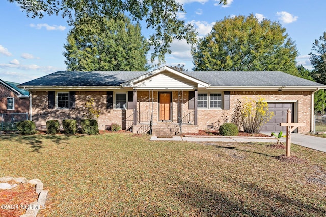 single story home featuring a porch, a garage, and a front lawn