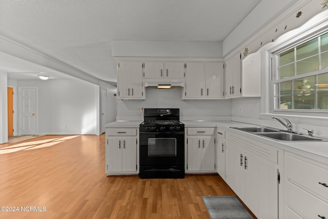 kitchen featuring white cabinets, light hardwood / wood-style floors, black range with gas stovetop, and sink