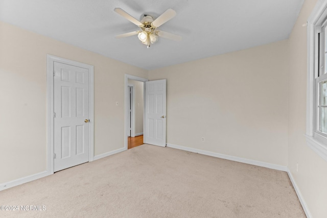 unfurnished bedroom with light carpet and ceiling fan