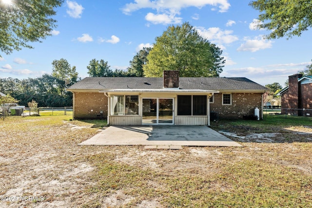 rear view of property featuring a patio and a sunroom