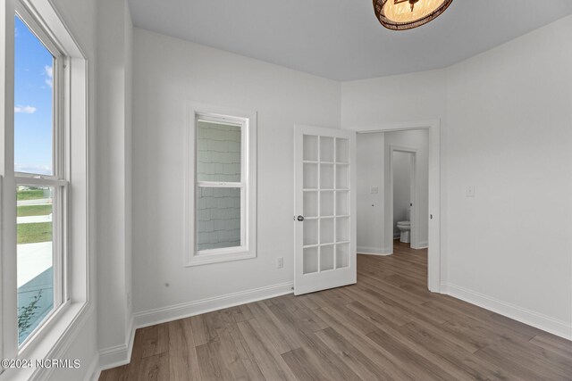 empty room with baseboards and wood finished floors