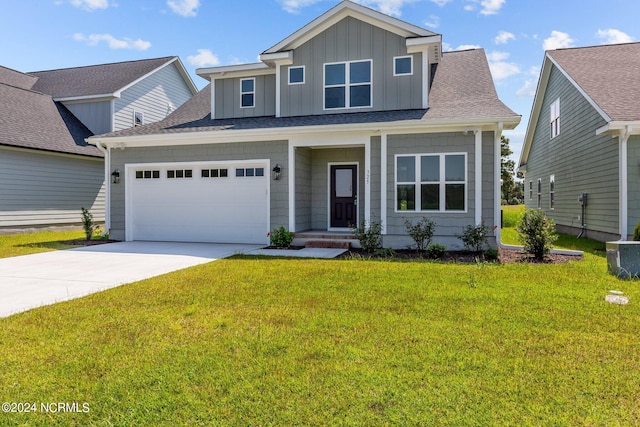 view of front of house with cooling unit, a front yard, and a garage