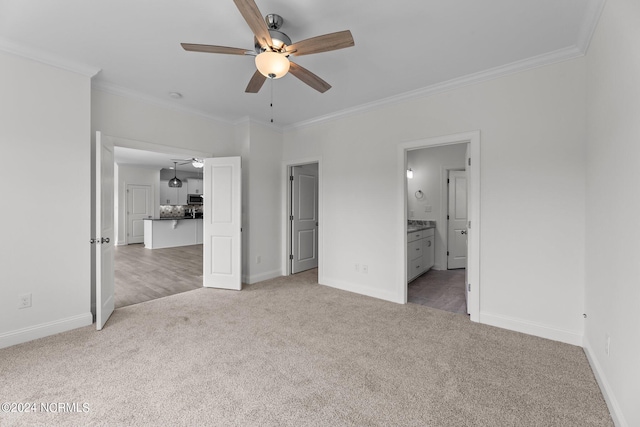 unfurnished bedroom with carpet, baseboards, and crown molding