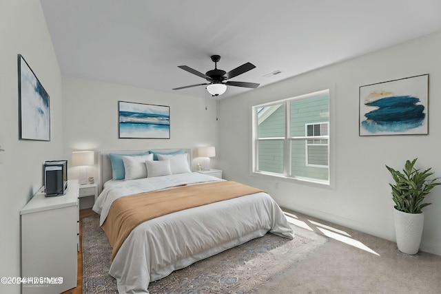 carpeted bedroom with ceiling fan and visible vents