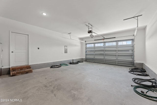 garage with electric panel and a garage door opener