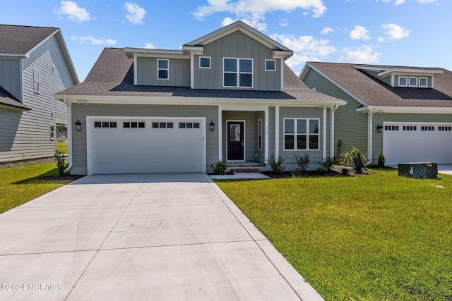 view of front of home with roof with shingles, a front lawn, board and batten siding, and concrete driveway