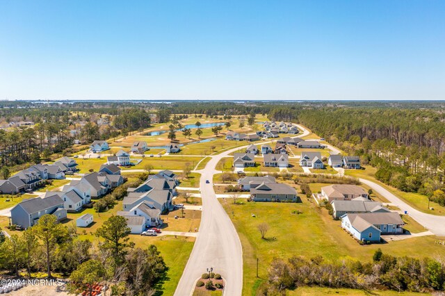 birds eye view of property featuring a residential view and a view of trees