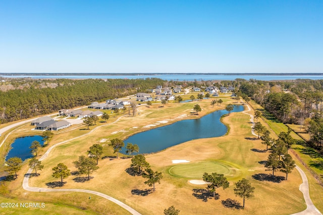 drone / aerial view featuring view of golf course and a water view