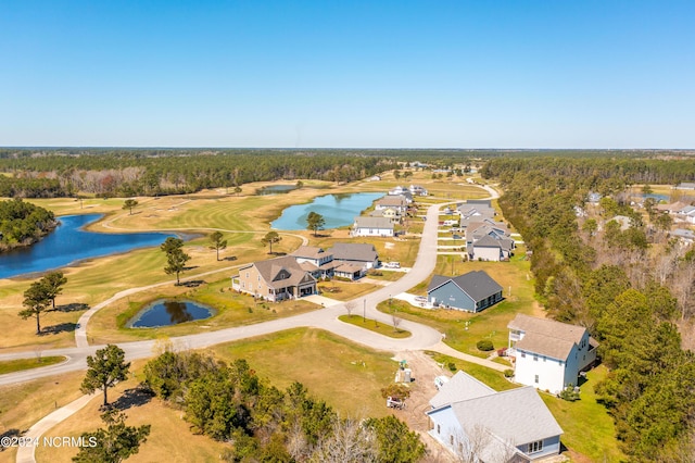 aerial view with view of golf course, a water view, and a view of trees