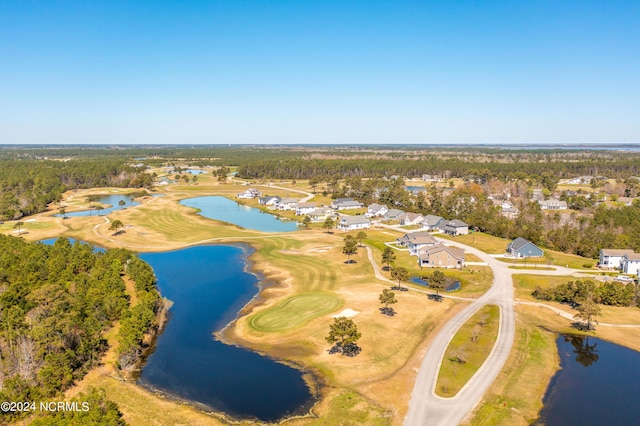 aerial view featuring a forest view and a water view