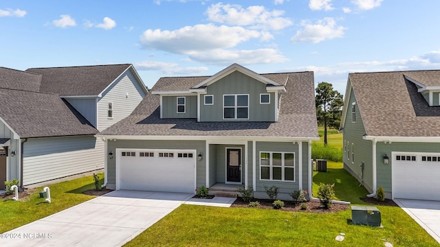 traditional-style home featuring board and batten siding, central AC unit, a front lawn, and concrete driveway