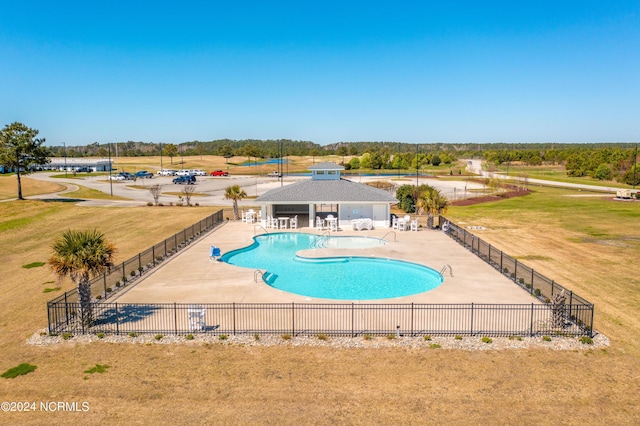 pool featuring a patio area and fence