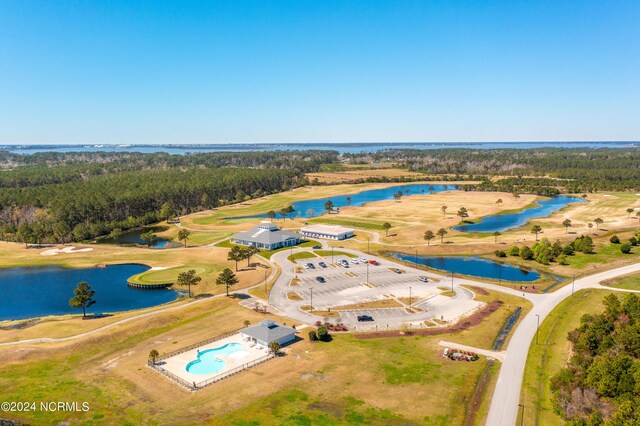 birds eye view of property featuring a water view and a view of trees