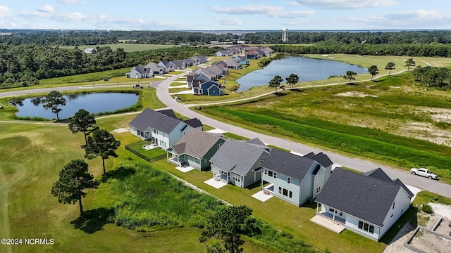 drone / aerial view with a water view and a residential view