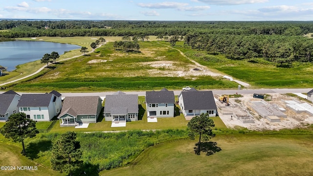 birds eye view of property featuring a residential view, a water view, and a wooded view