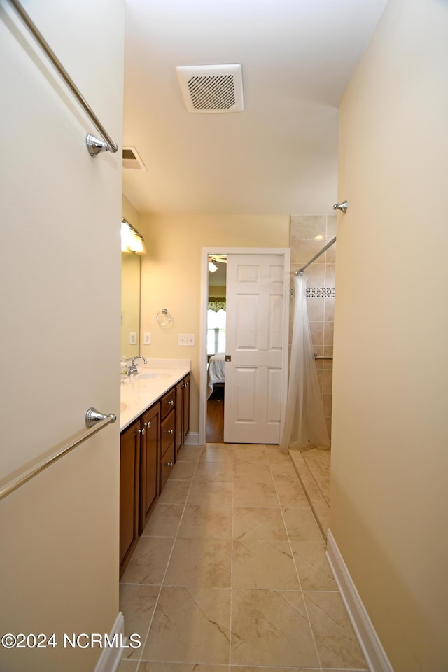 bathroom with tile patterned flooring, a shower with curtain, and vanity