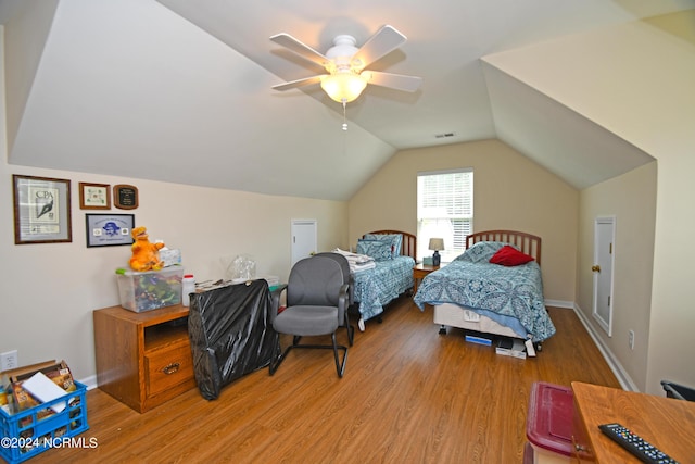 bedroom featuring ceiling fan, light wood-type flooring, and vaulted ceiling