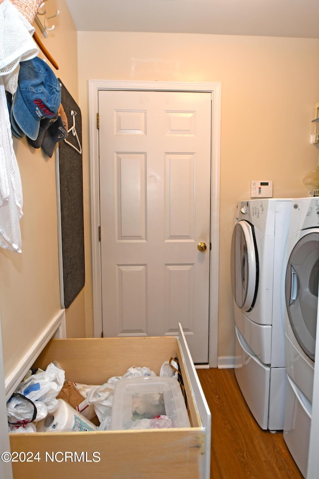 washroom with separate washer and dryer and wood-type flooring