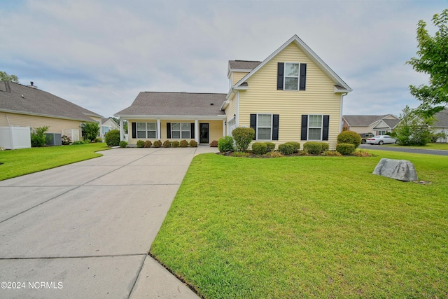 view of front of property with cooling unit and a front lawn