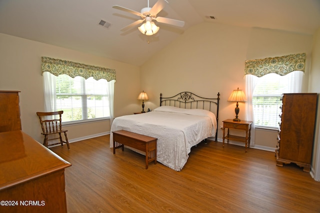 bedroom featuring hardwood / wood-style floors, vaulted ceiling, and ceiling fan