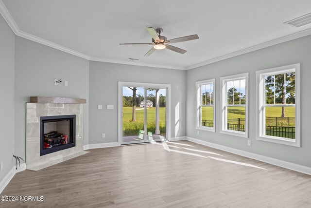 unfurnished living room with light hardwood / wood-style flooring, ceiling fan, and crown molding