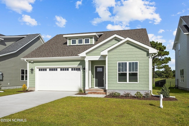 craftsman-style house featuring a front lawn and a garage