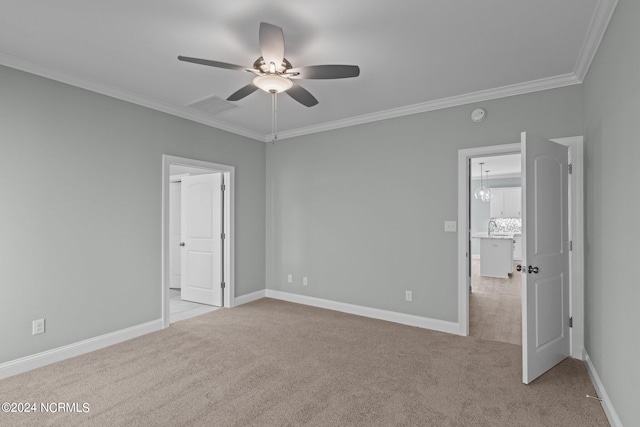 unfurnished bedroom featuring light colored carpet, ceiling fan, and ornamental molding